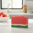Watermelon-themed soap bar on a kitchen counter with watermelon slices in the background.